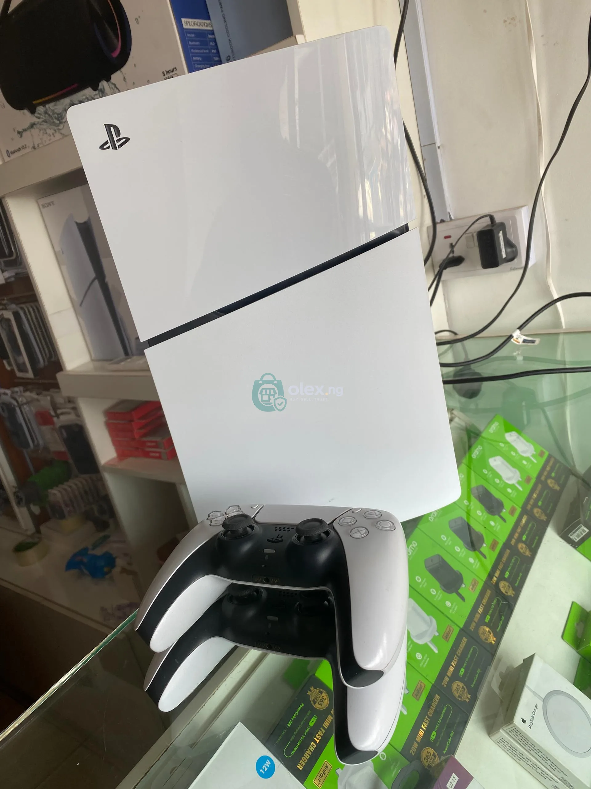 PlayStation 5 slim with two controller pads and FC 26 disk